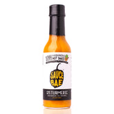 Front view of a 5 oz bottle of Sauce Bae Skinny Habanero Hot Sauce with turmeric, featuring a black and white label, yellow pepper logo, and a small pineapple icon.